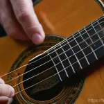 Home 12 기타 튜닝 머신 종류 - **Prompt:** A close-up, artistic shot of a musician's hands gently adjusting a sophisticated, high-r...